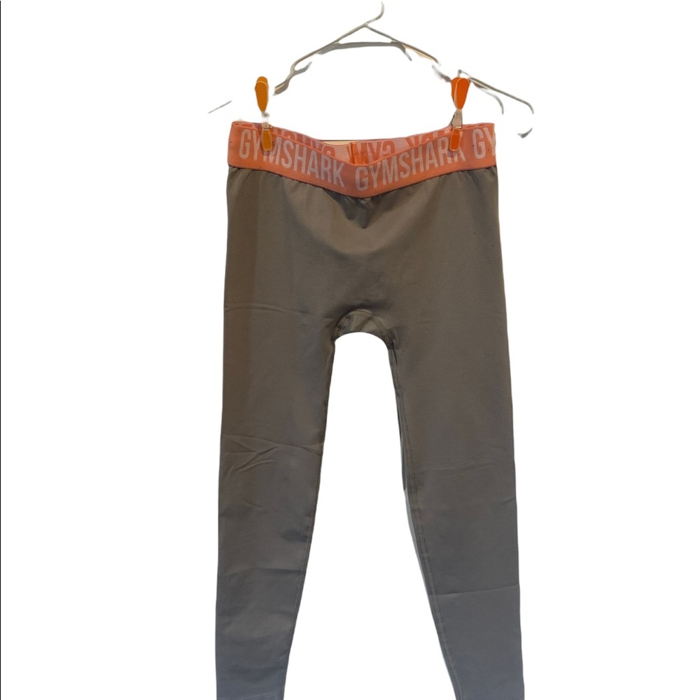 Gymshark light gray leggings with pink orange coral waistband.